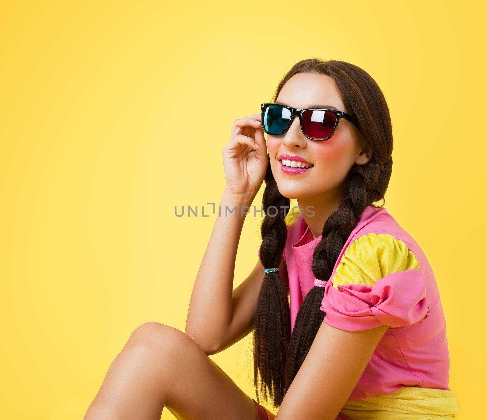 Cute girl like doll dress look in stereo glasses on yellow background