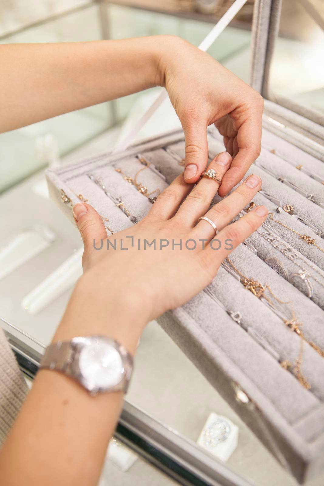 Vertical shot of unrecognizable woman trying on rings at jewelry store