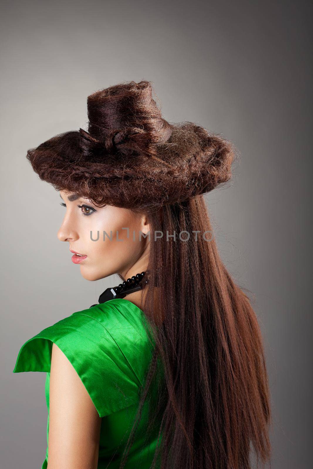 Woman portrait in hair style like hat on grey by rivertime