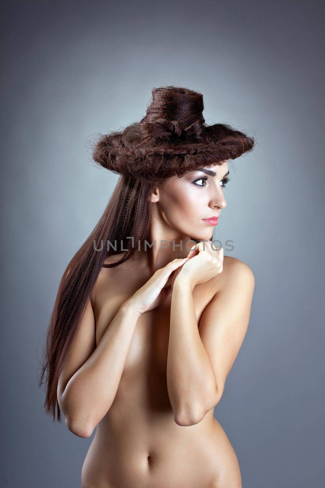 Sexy naked woman with hair style close breast look at light
