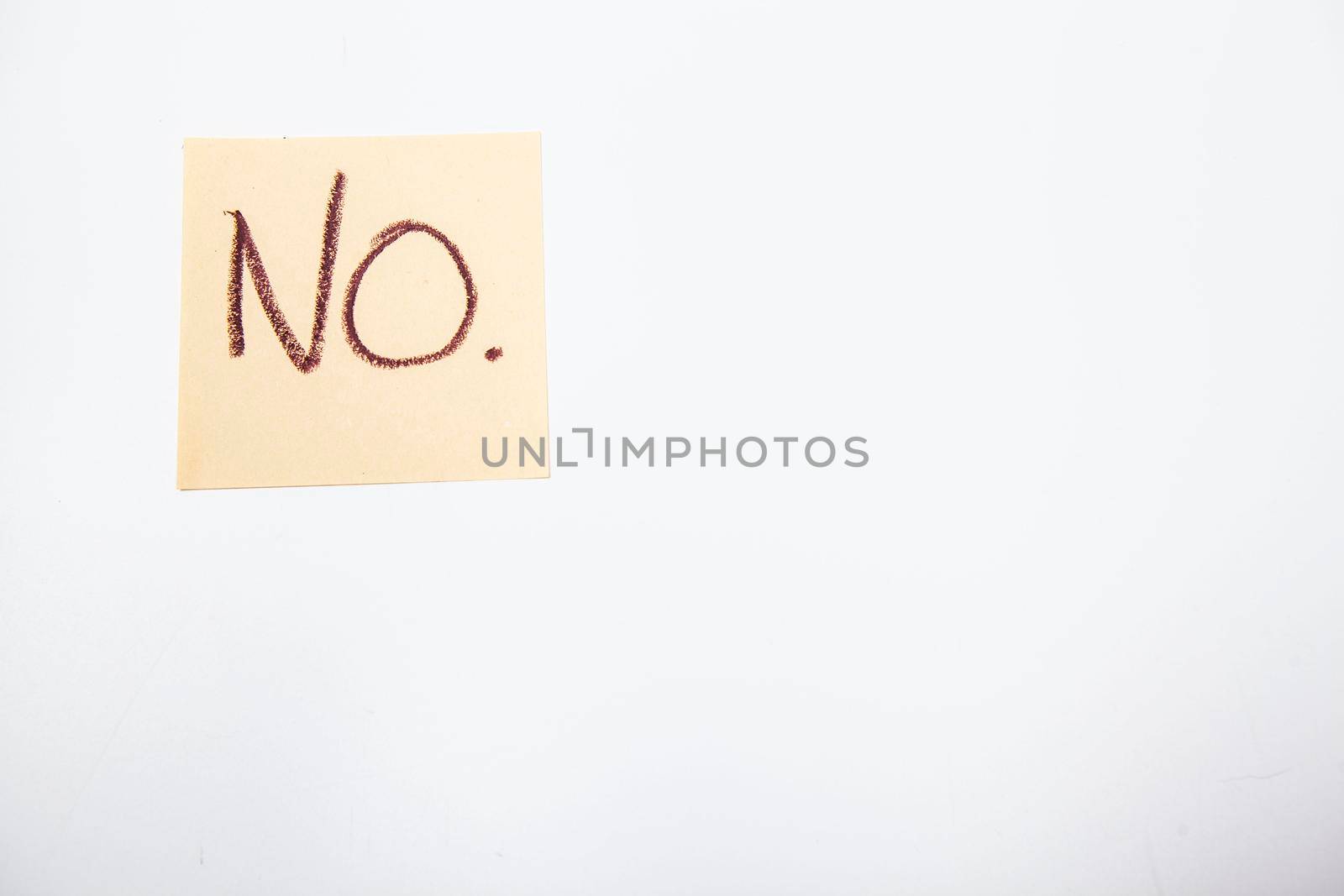 Text written NO on yellow note pad isolated