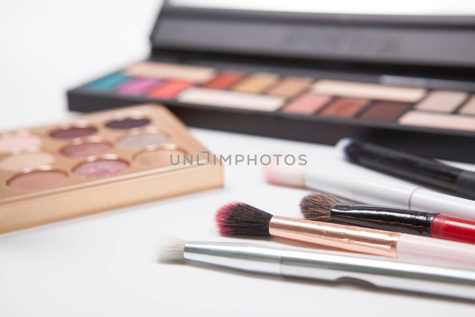 Close up of makeup brushes and eyeshadow palettes