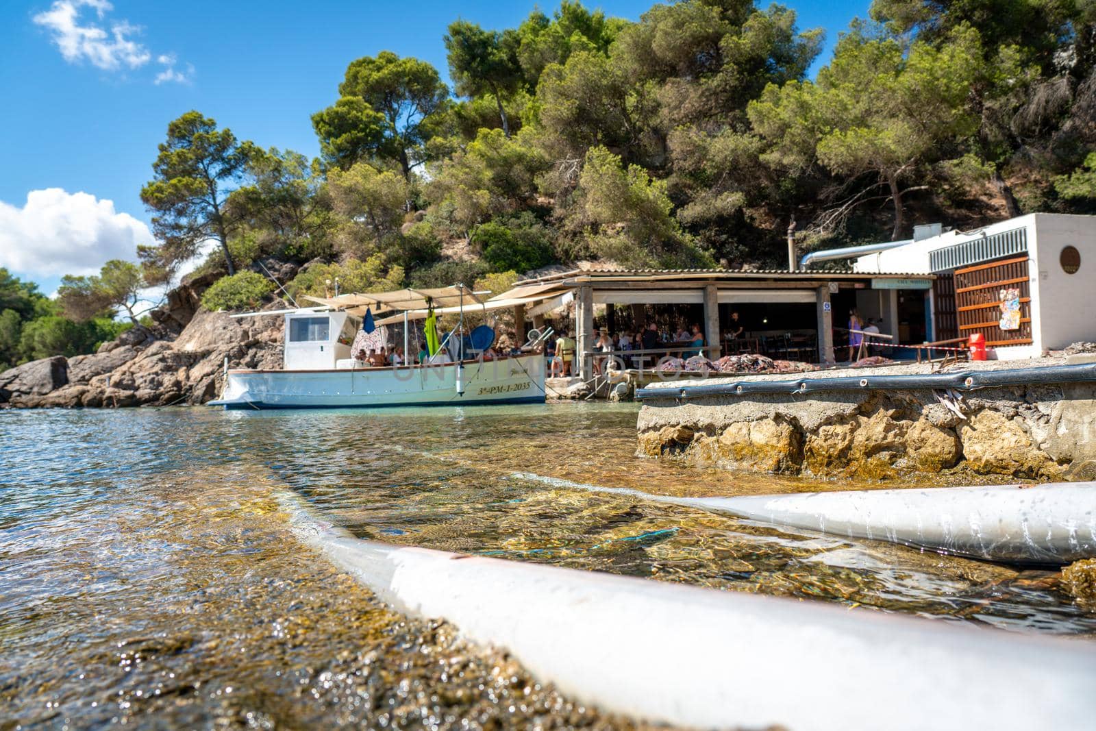 View of the Ibizan Cala Mastella and El Bigotes Restaurant by LopezPastor