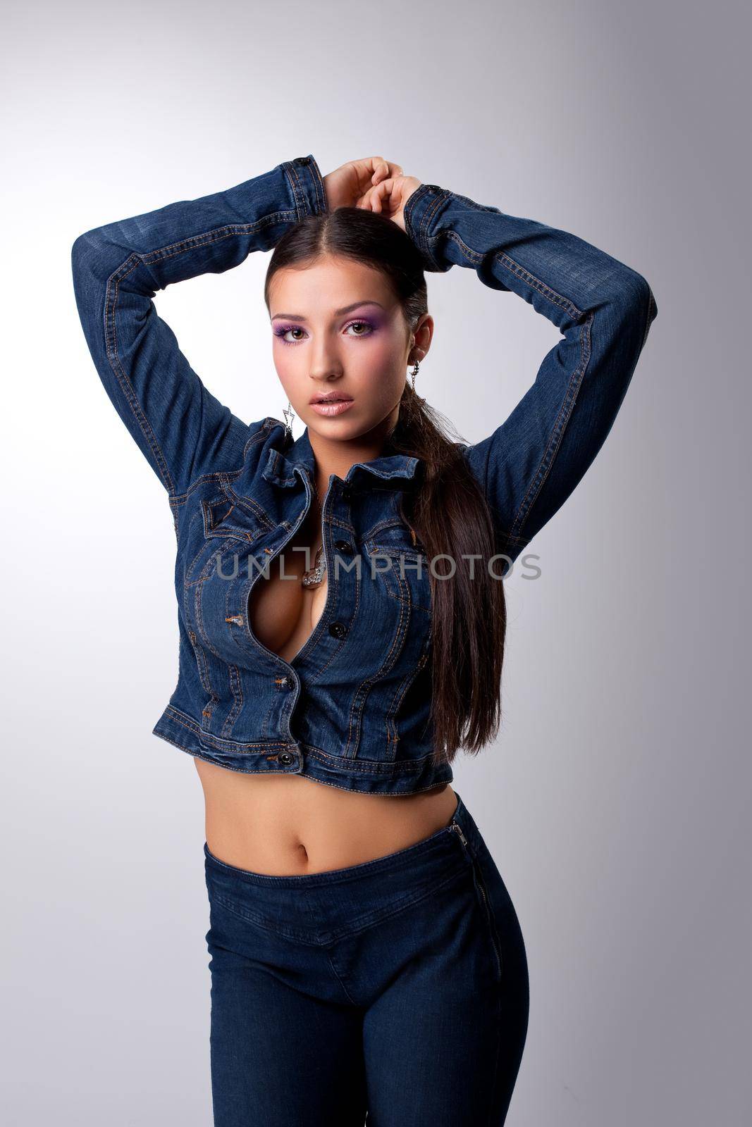 Young and sexy girl look at camera - hip-hop jeans style