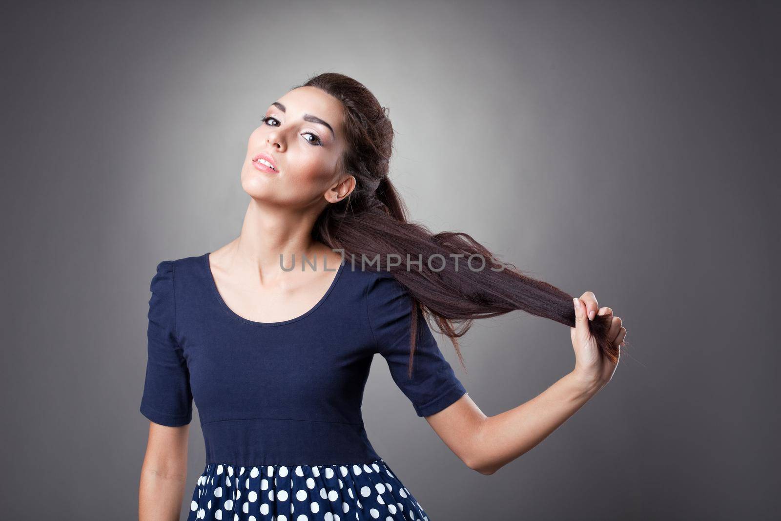 Yong cute woman portrait in old-fashioned cloth take her hairs