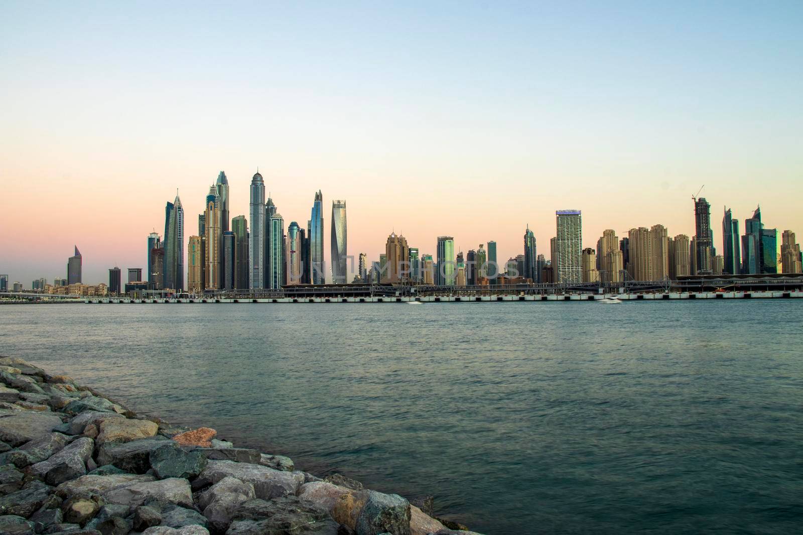 View of A Dubai Marina during sunset hour. Shot made from Palm Jumeirah, man made island. Dubai, UAE. Outdoors.