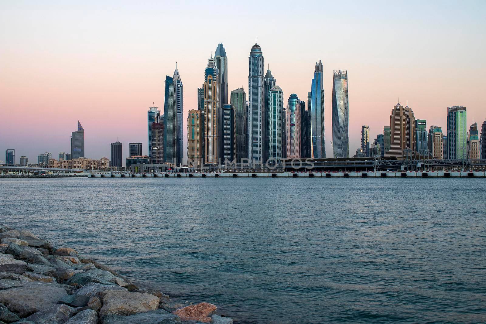 View of A Dubai Marina during sunset hour. Shot made from Palm Jumeirah, man made island. Dubai, UAE. Outdoors.