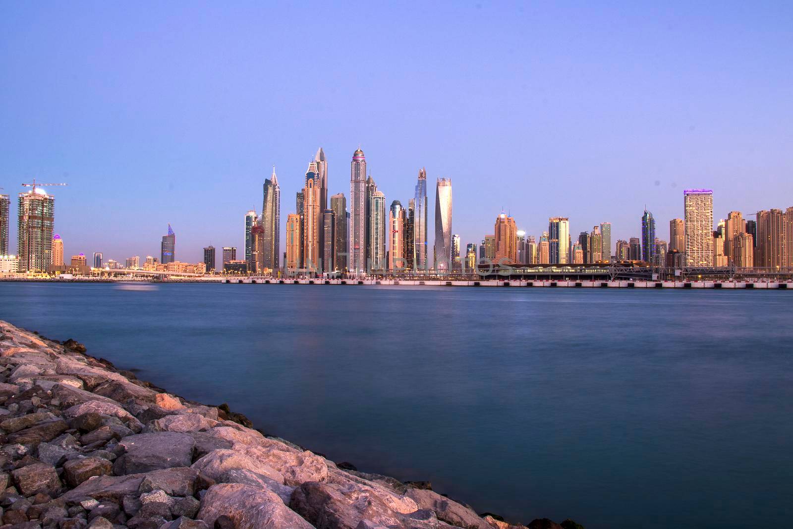 View of A Dubai Marina after sunset. Shot made from Palm Jumeirah, man made island. Dubai, UAE. Outdoors.