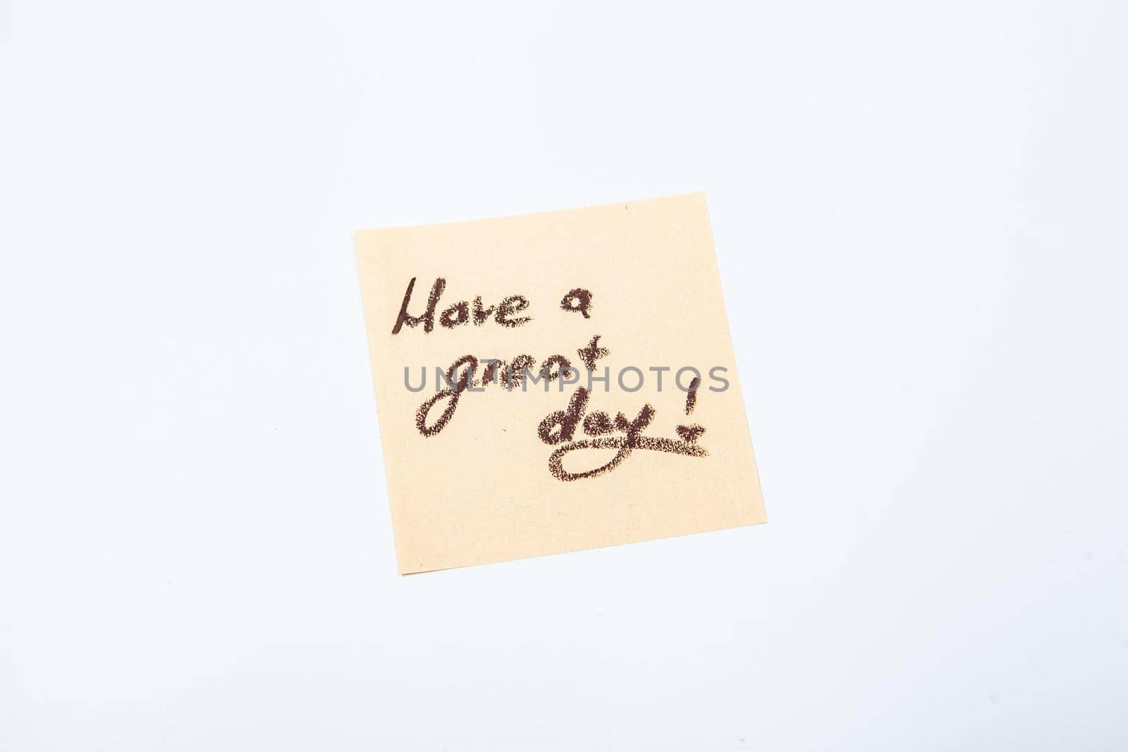 Have a great day message handwritten on yellow post-it note