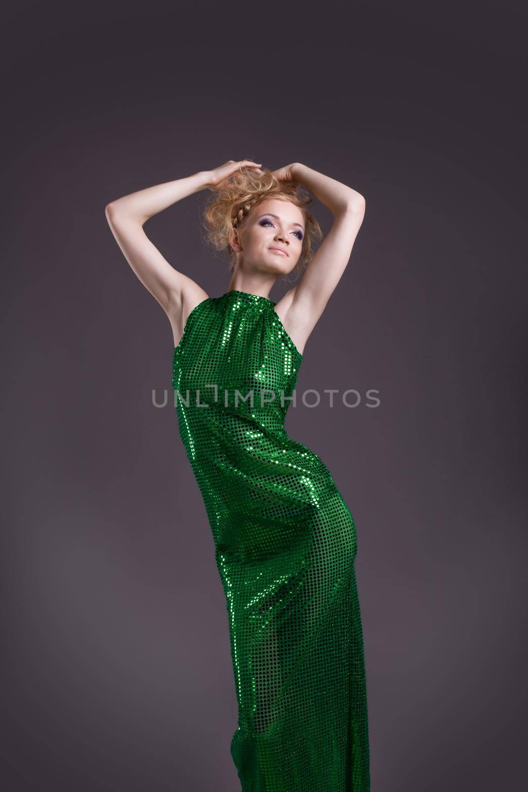 Amazing young naked blond woman posing in transparent green costume