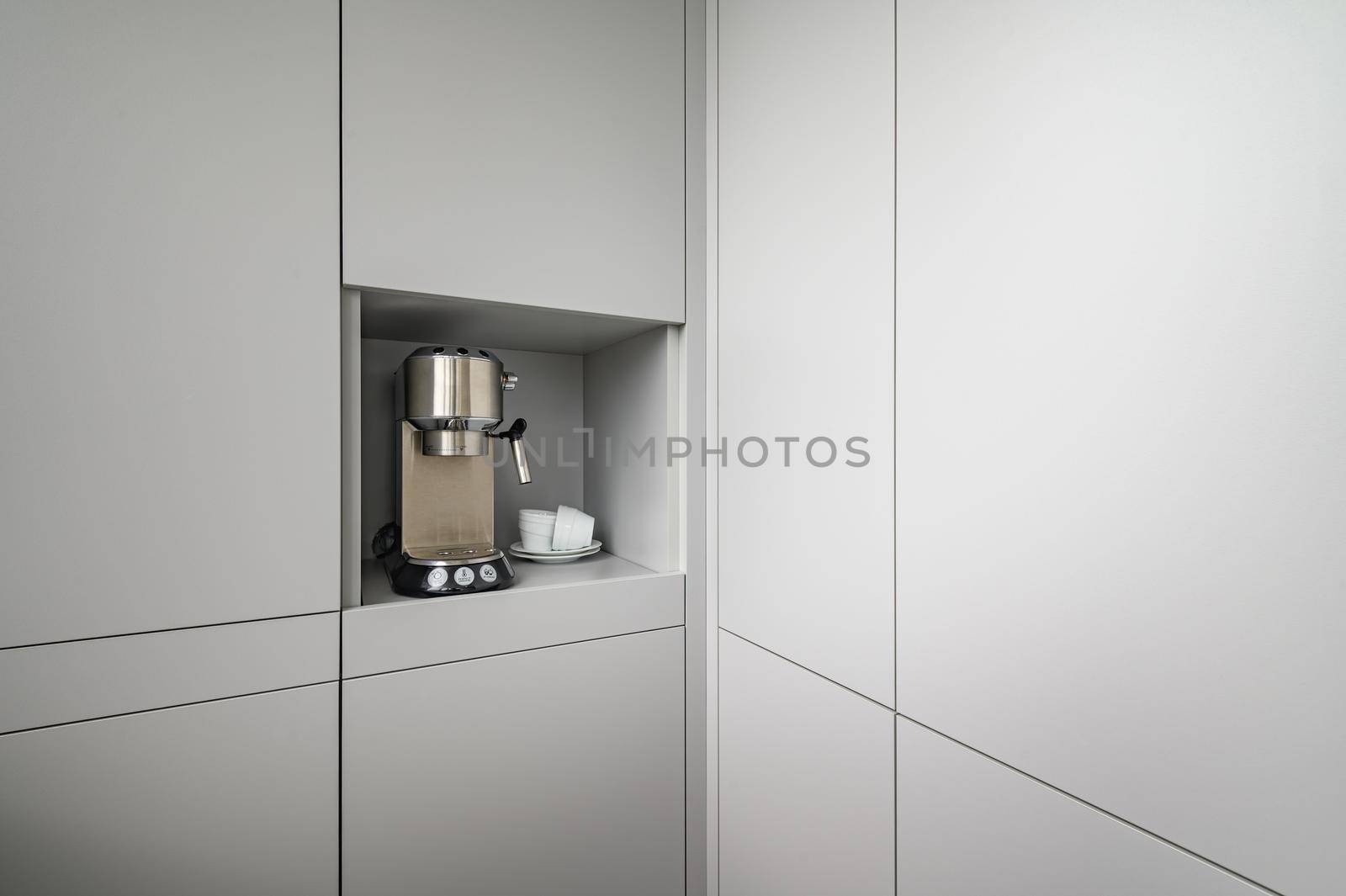 Modern gray kitchen corner with espresso coffee machine, concept photo, lot of copy space