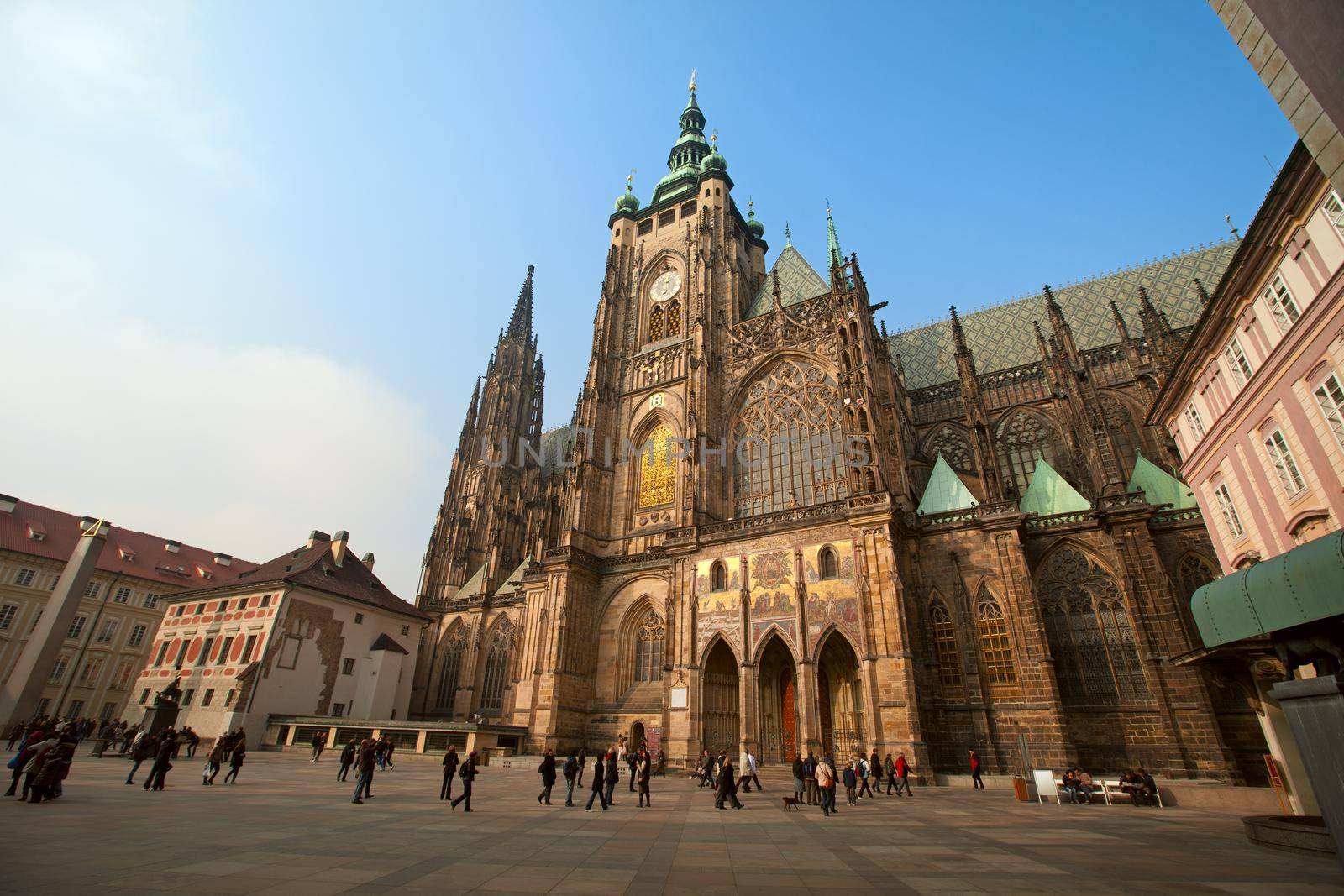 Historical Prague square and tourist walk around at autumn sunset