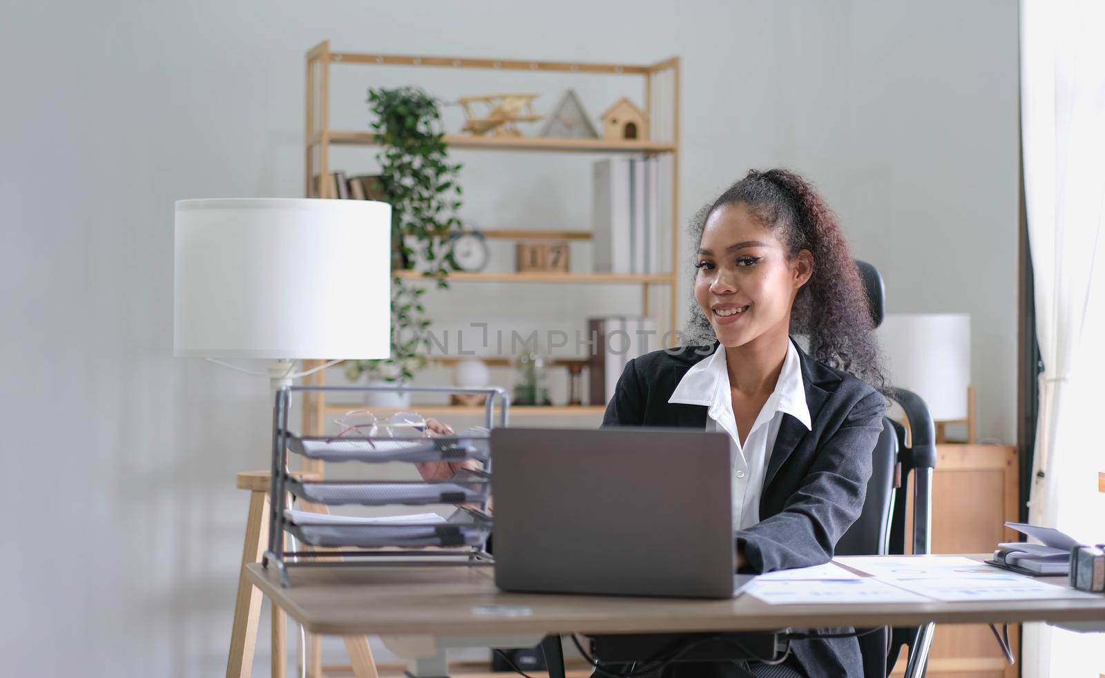 cheerful smiling business woman sitting at the office happy african american businessman in office by wichayada