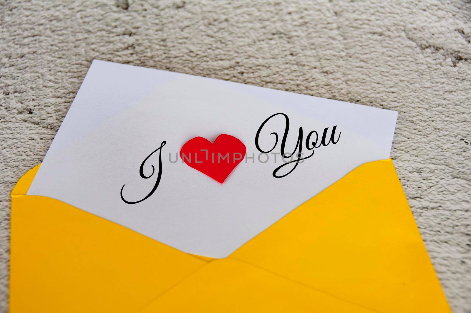 I love you text on notepad in yellow envelope. Romance and relationship concept.