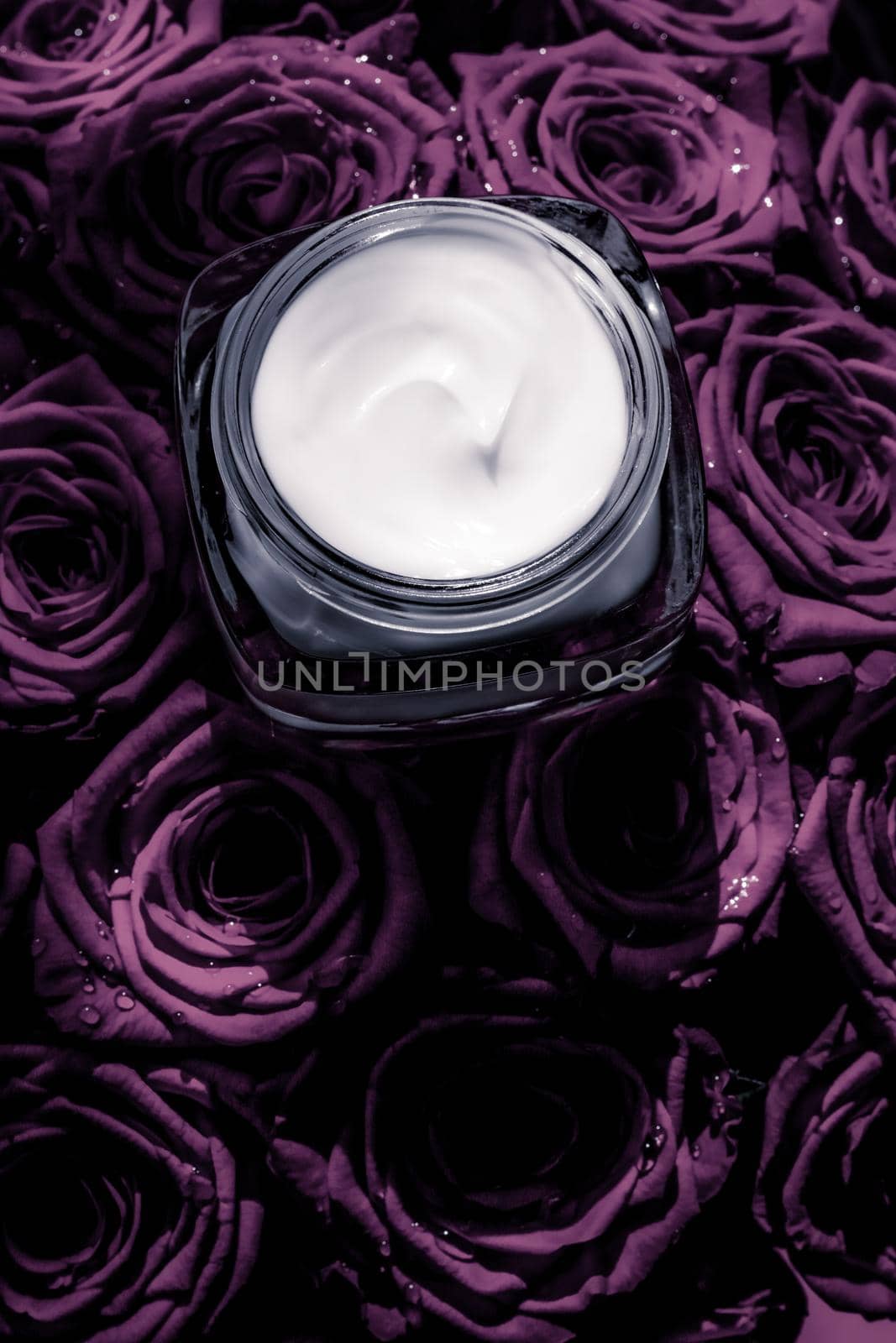 Luxe cosmetics, branding and anti-age concept - Face cream skin moisturizer on purple roses flowers, luxury skincare cosmetic product on floral background as beauty brand holiday flatlay design