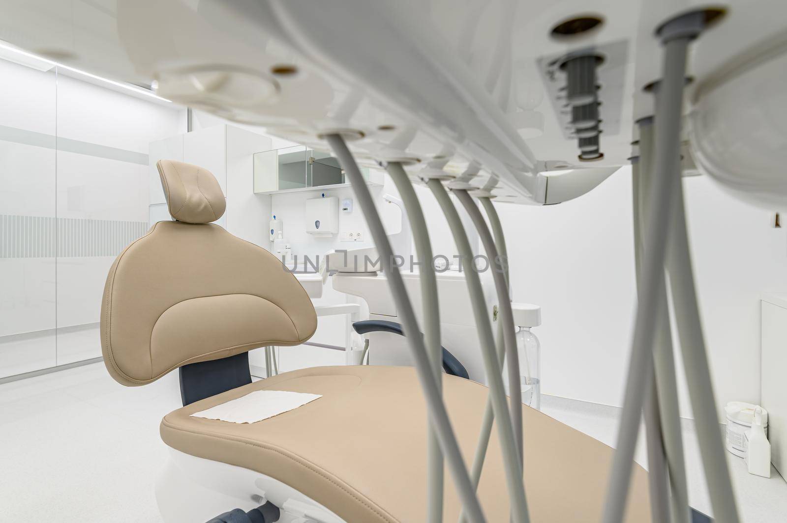 closeup of patient chair in Interior of white modern dentistry medical room with special equipment