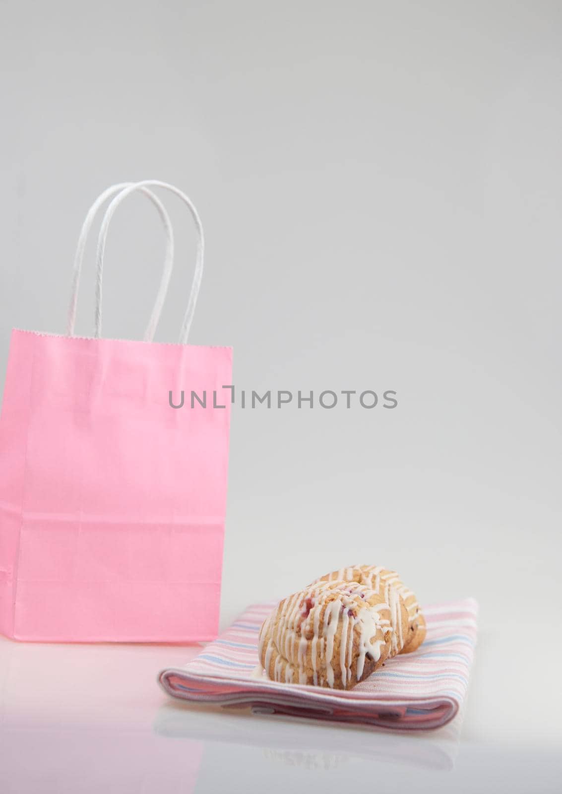 cookies glazed in pink shopping bag on a white background. The concept of copy space.
