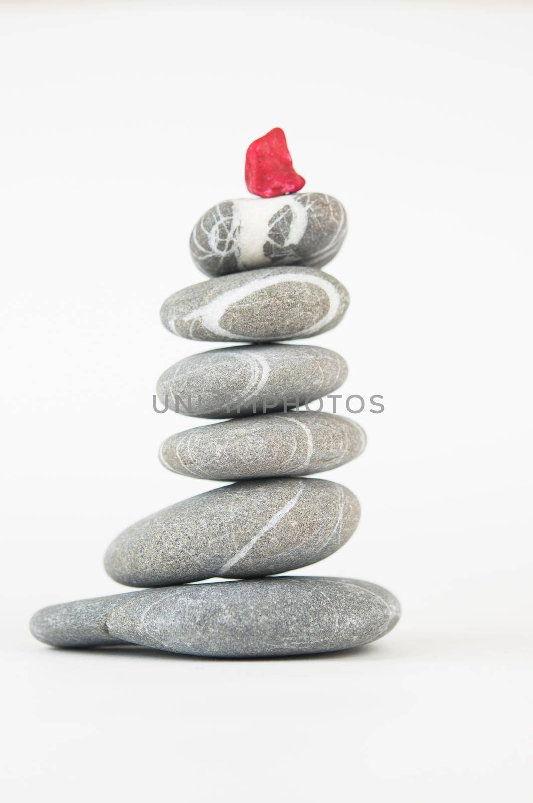 Balanced gray zen pebbles on white background. Zen stones. Spa and healthcare concept. 