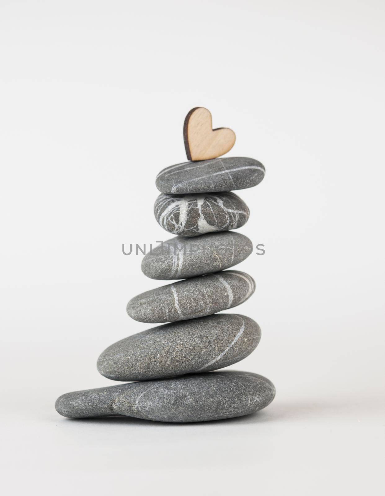 Balanced gray zen pebbles on white background. Zen stones. Spa and healthcare concept. 