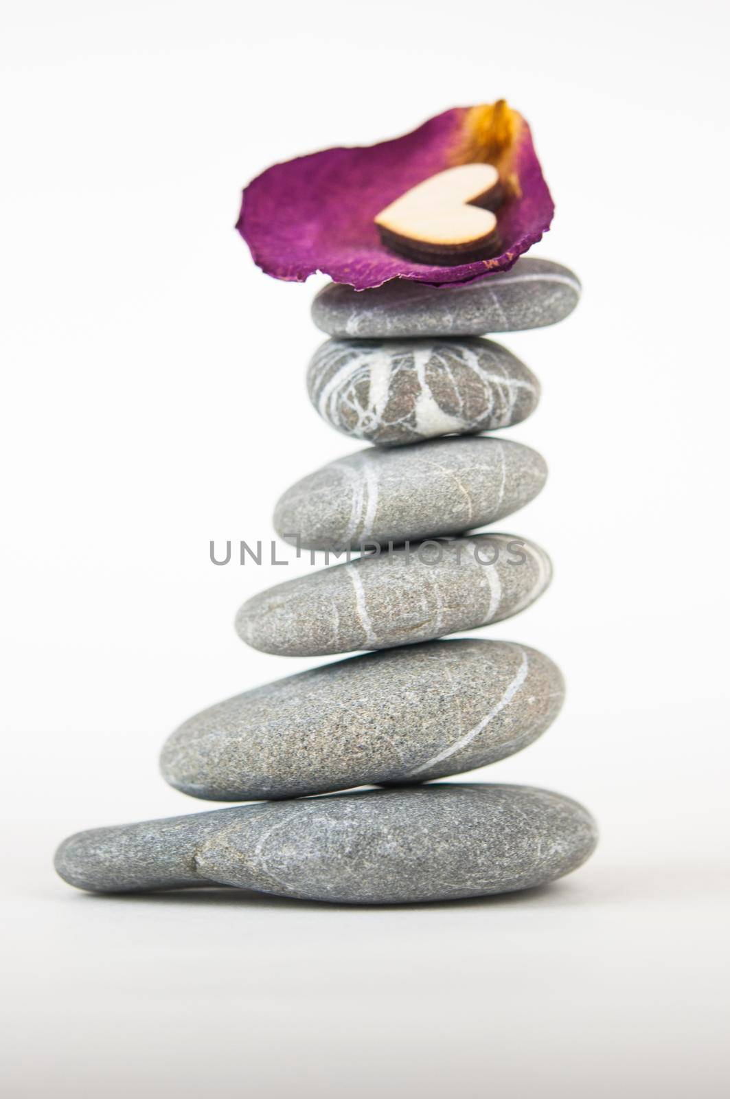 Balanced gray zen pebbles on white background. Zen stones. Spa and healthcare concept. 