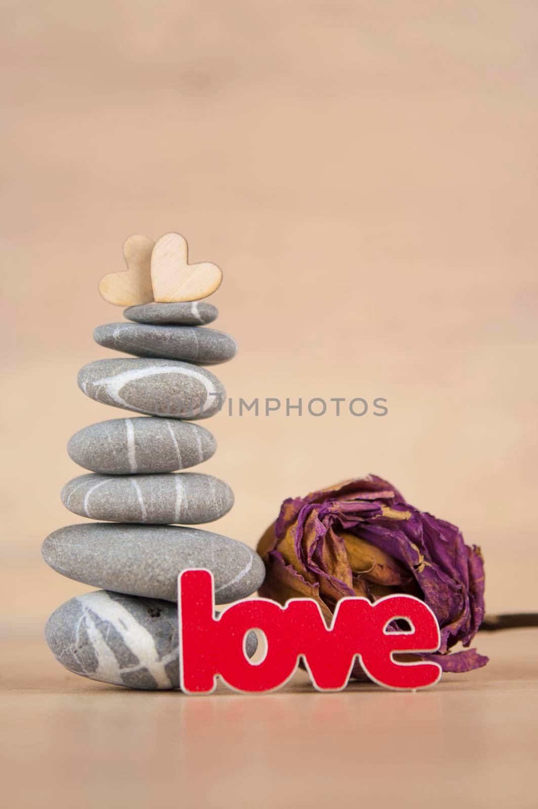Stone cairn on wood background, simple poise stones, simplicity harmony and balance, rock zen sculptures by inxti