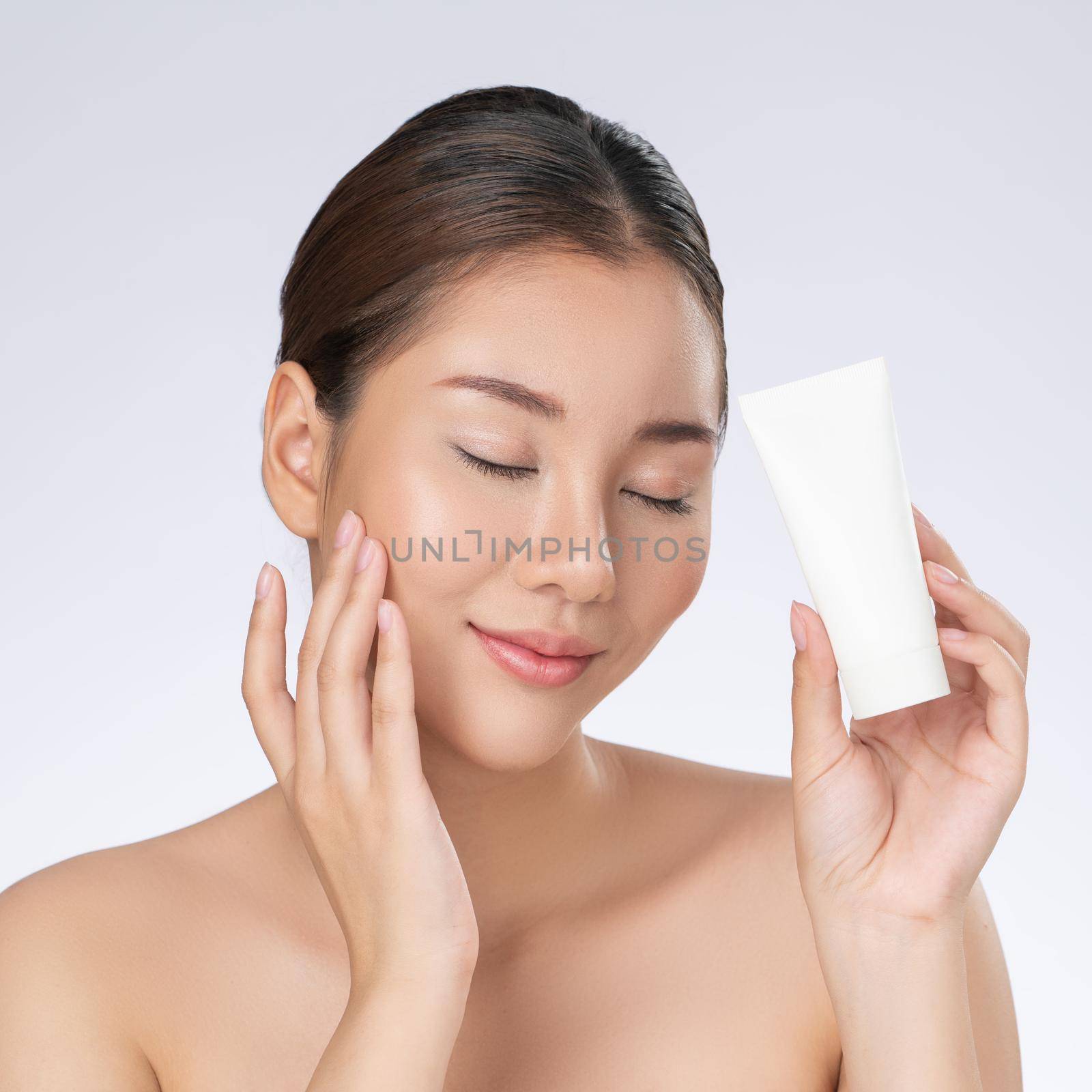 Gorgeous woman smiling holding mockup product for advertising text place. by biancoblue