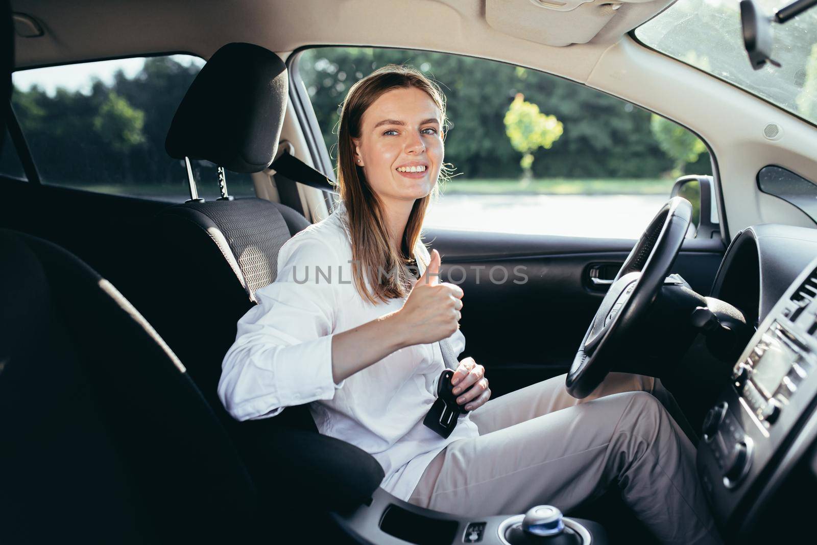 The woman behind the wheel pinches the seat belt