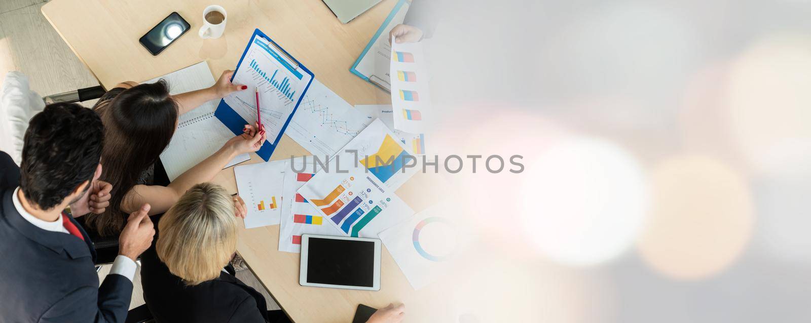 Business people group meeting shot from top widen view in office . Profession businesswomen, businessmen and office workers working in team conference with project planning document on meeting table .