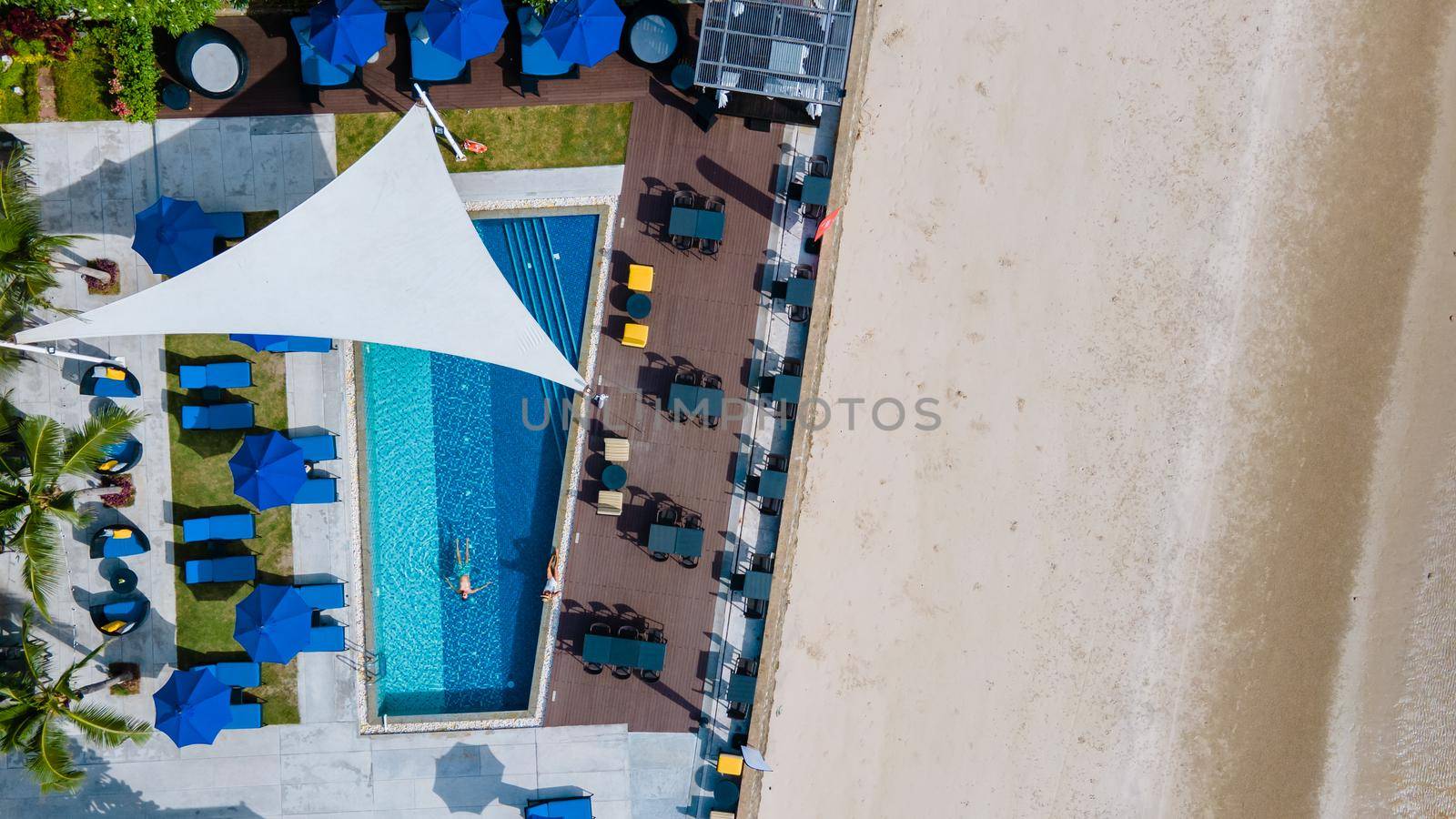 Aerial view from above at pool, tropical swimming pool from above with drone by fokkebok