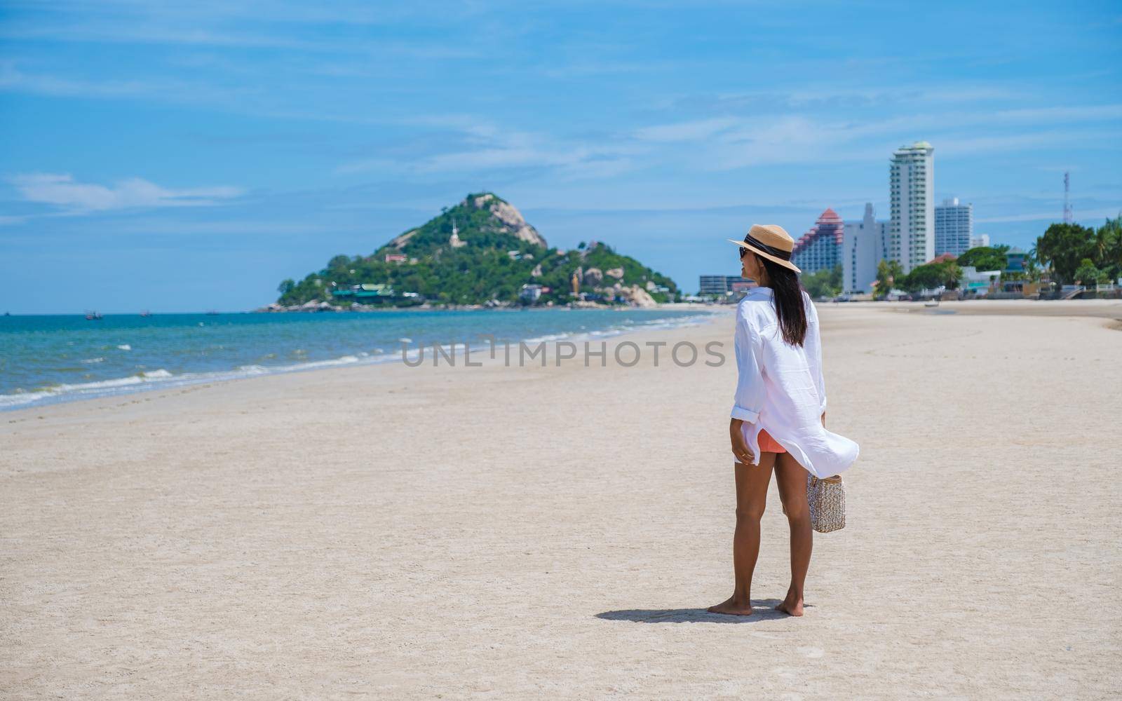 Asian women walking on the beach in the morning at Takiab Beach Huahin Thailand