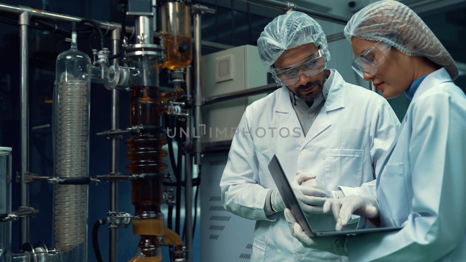 Two scientist in professional uniform working in laboratory for chemical and biomedical experiment