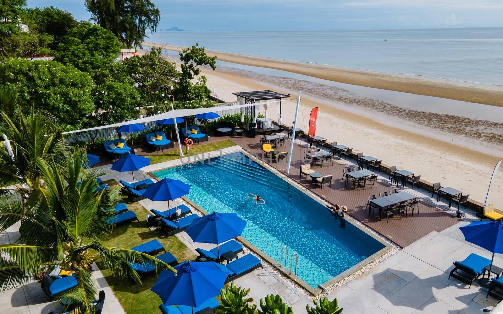 Aerial view from above at pool, tropical swimming pool from above with drone by fokkebok