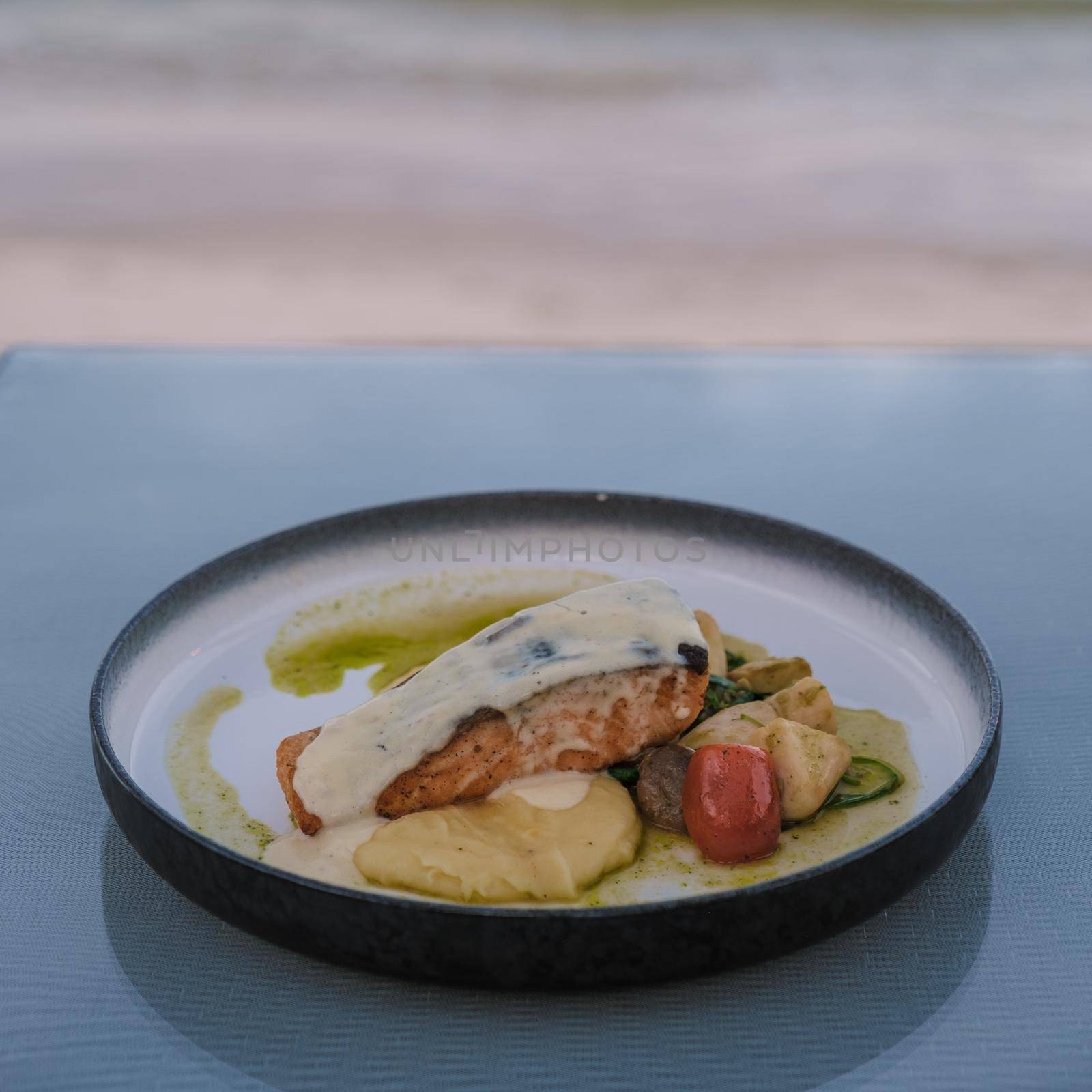 roasted salmon on a plate with potatoes purree.