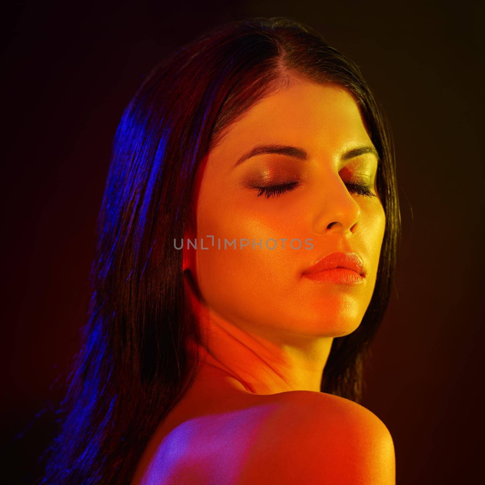 Her beauty lights up a room. Studio shot of a beautiful young woman with artistic lighting. by YuriArcurs