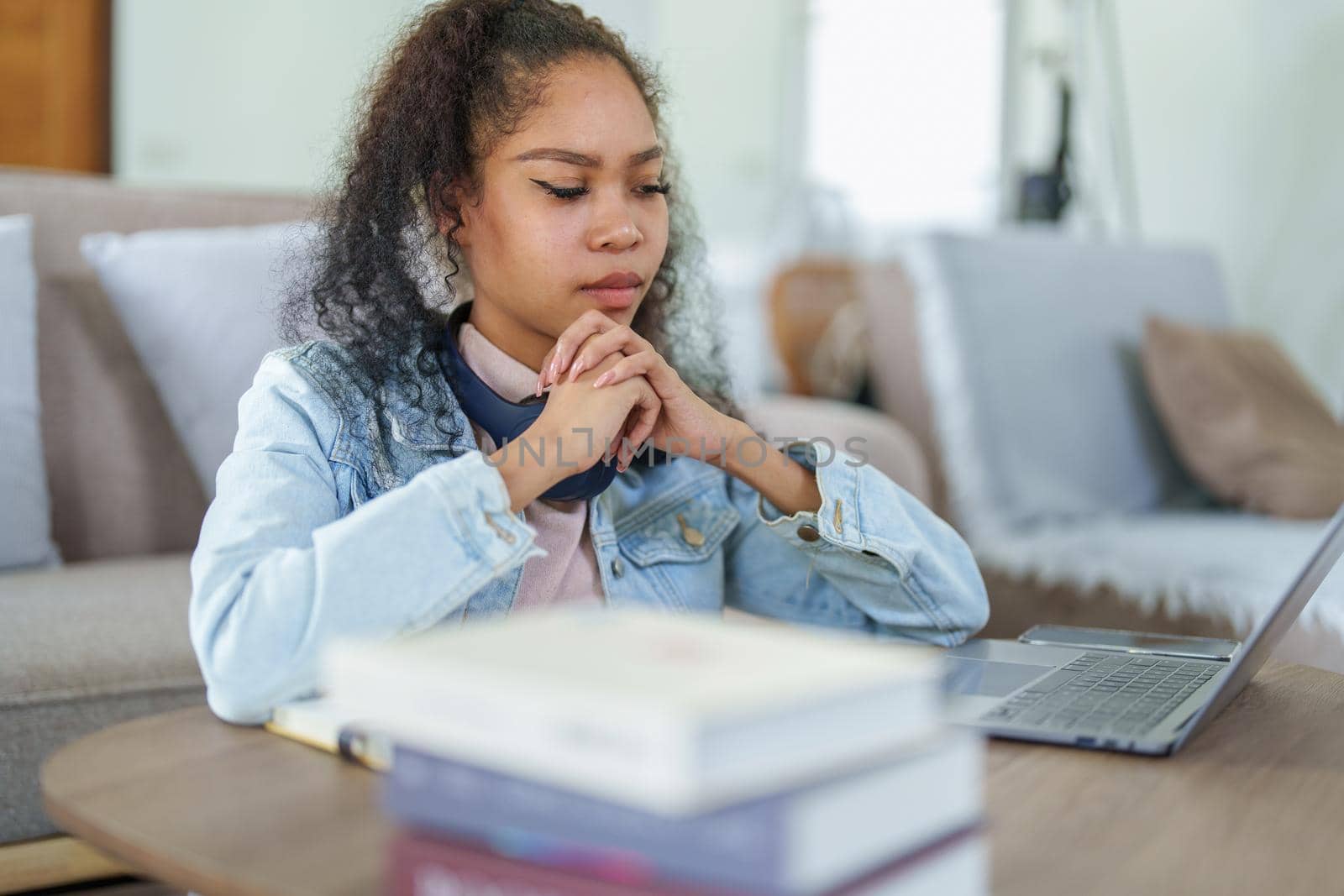 Portrait of African Americans using computers and notebooks to study online and showing doubtful faces at lessons they have learned.