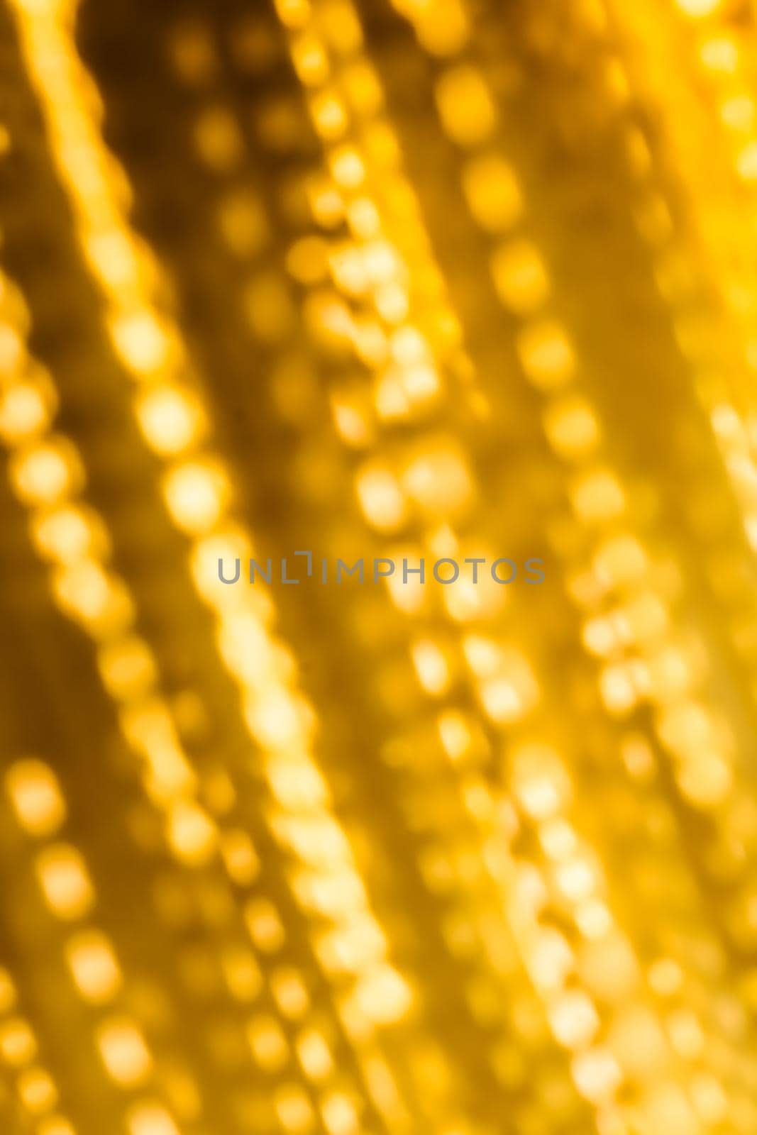 Golden Christmas lights, New Years Eve fireworks and abstract texture concept - Glamorous gold shiny glow and glitter, luxury holiday background