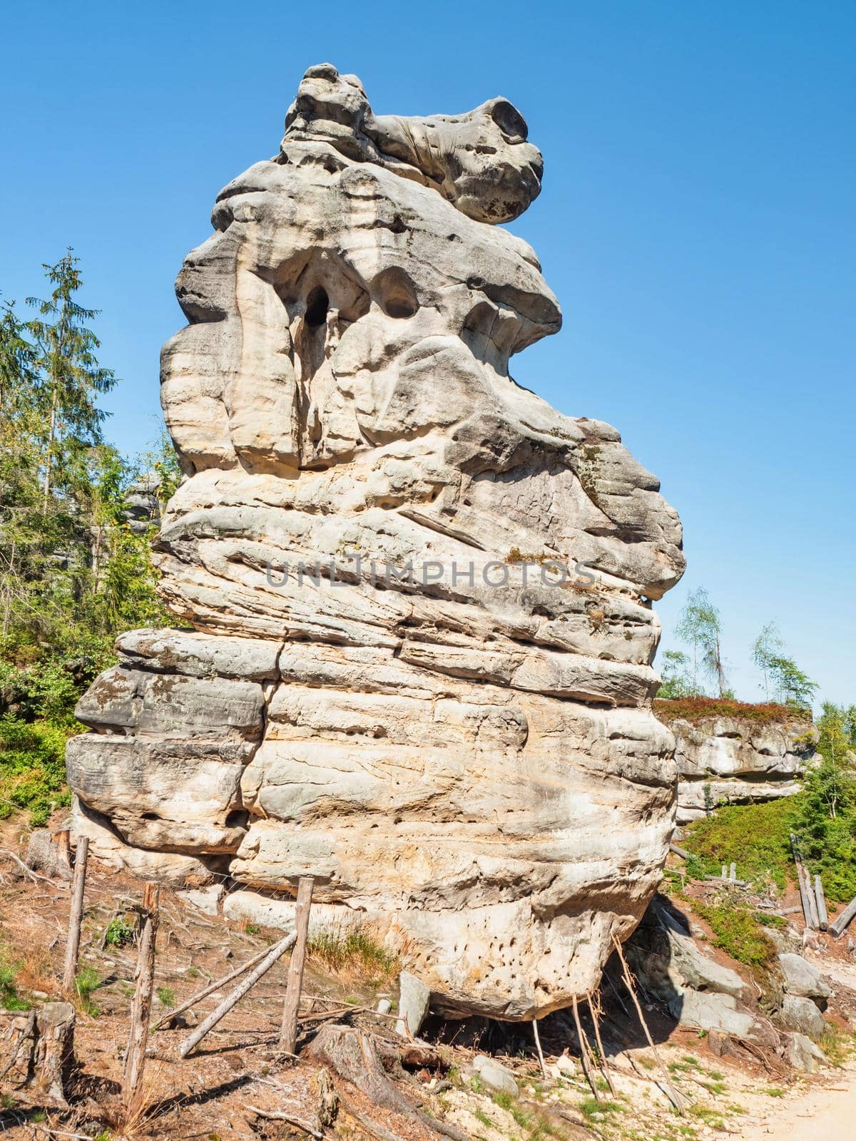 Sandstone tower at entrance to rocky labirynth Ostas Table Mountain, part of Broumovsko Protected Landscape Area in Czech Republic