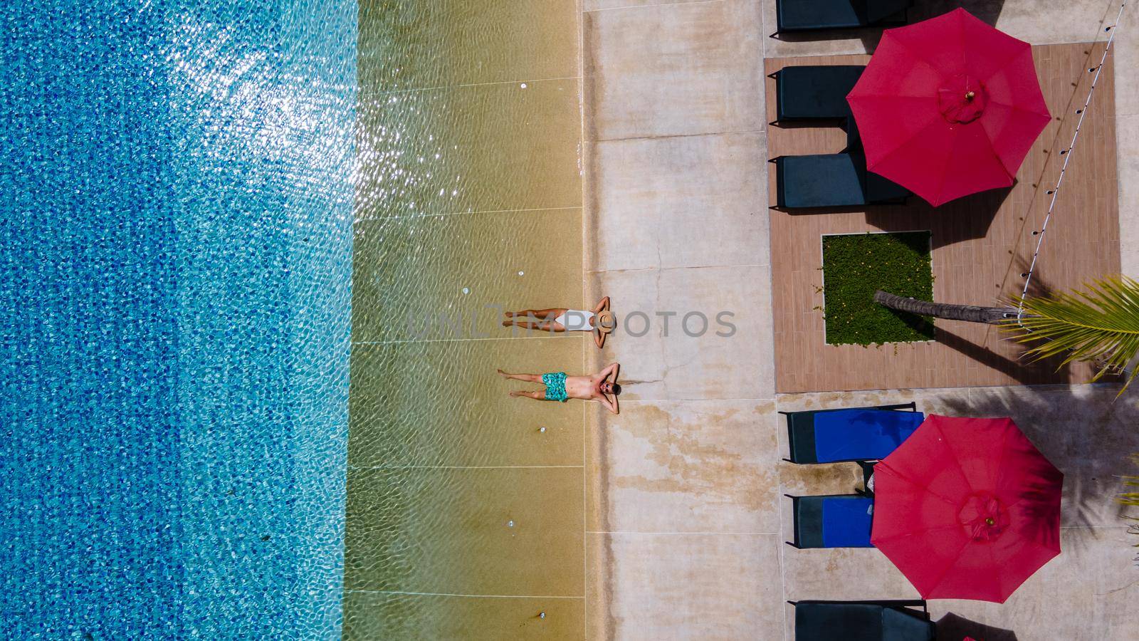 Aerial view from above at pool, tropical swimming pool from above with drone by fokkebok