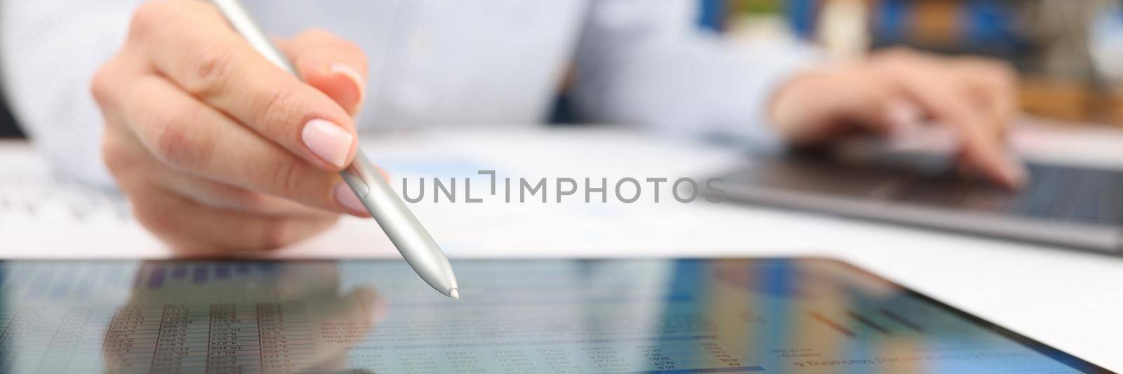 Female hand studying information on digital tablet with stylus closeup. Management concept