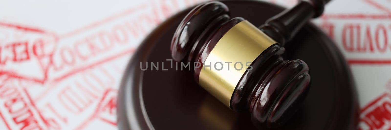 Judge gavel lying on documents stamped with covid19 red seal closeup. Criminal liability for intentional infection of covid 19 concept