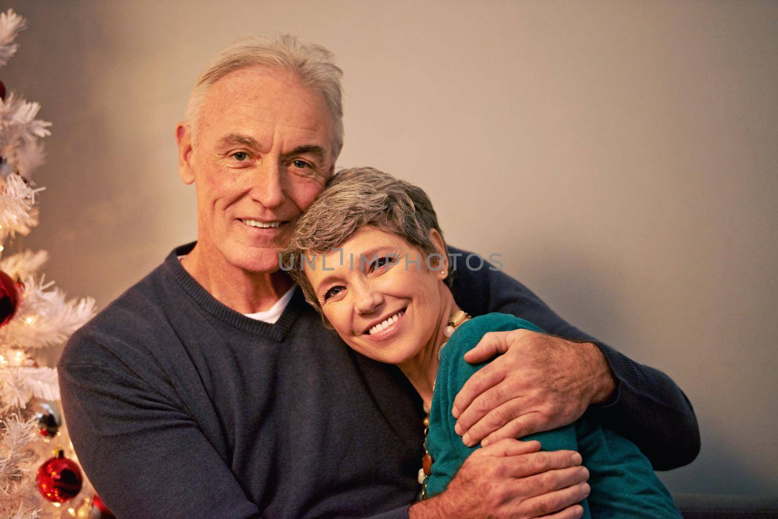 A romantic Christmas eve. Cropped portrait of a happy mature couple beside a Christmas tree. by YuriArcurs