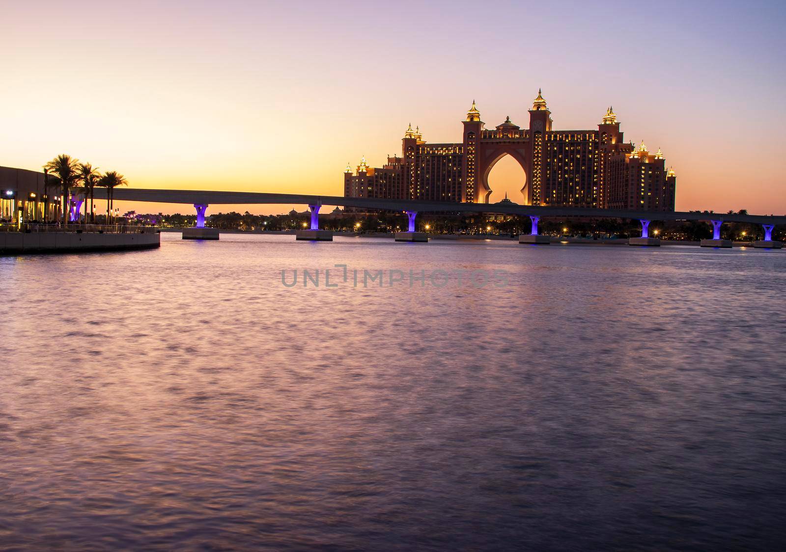 Atlantis, popular five star hotel in Dubai, UAE at night. Monorail leading to the hotel also can be seen in the picture. by pazemin