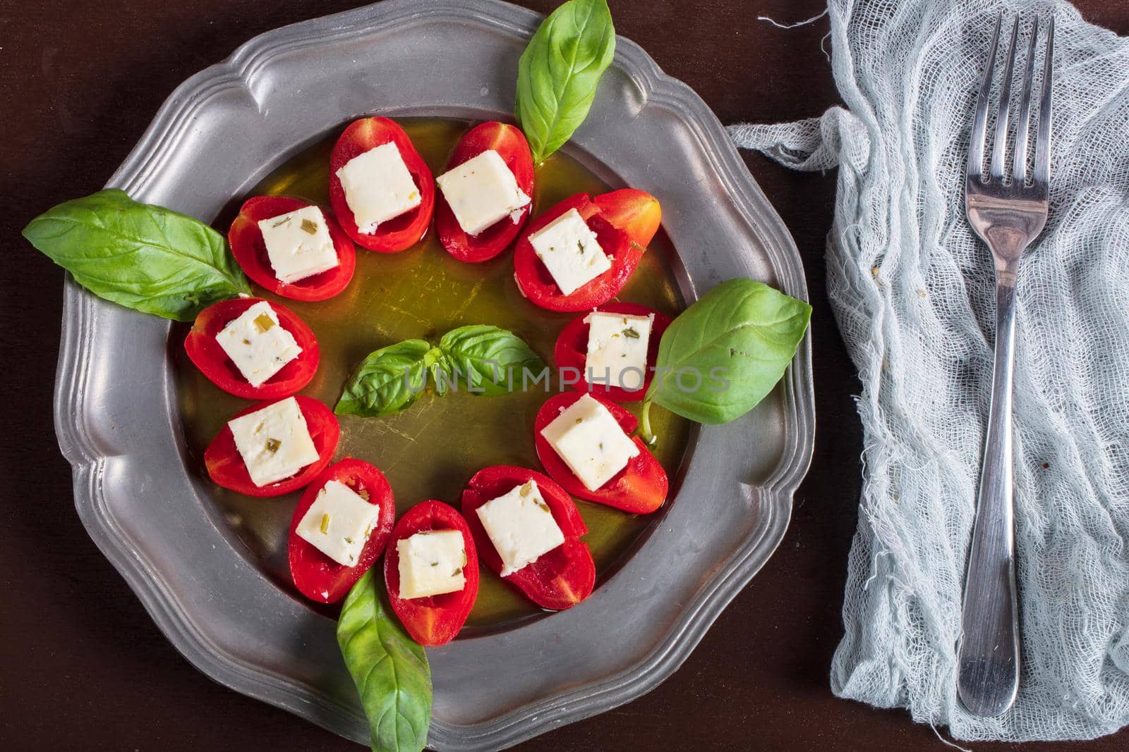 Stuffed tomatoes with cheese and basil . High quality photo