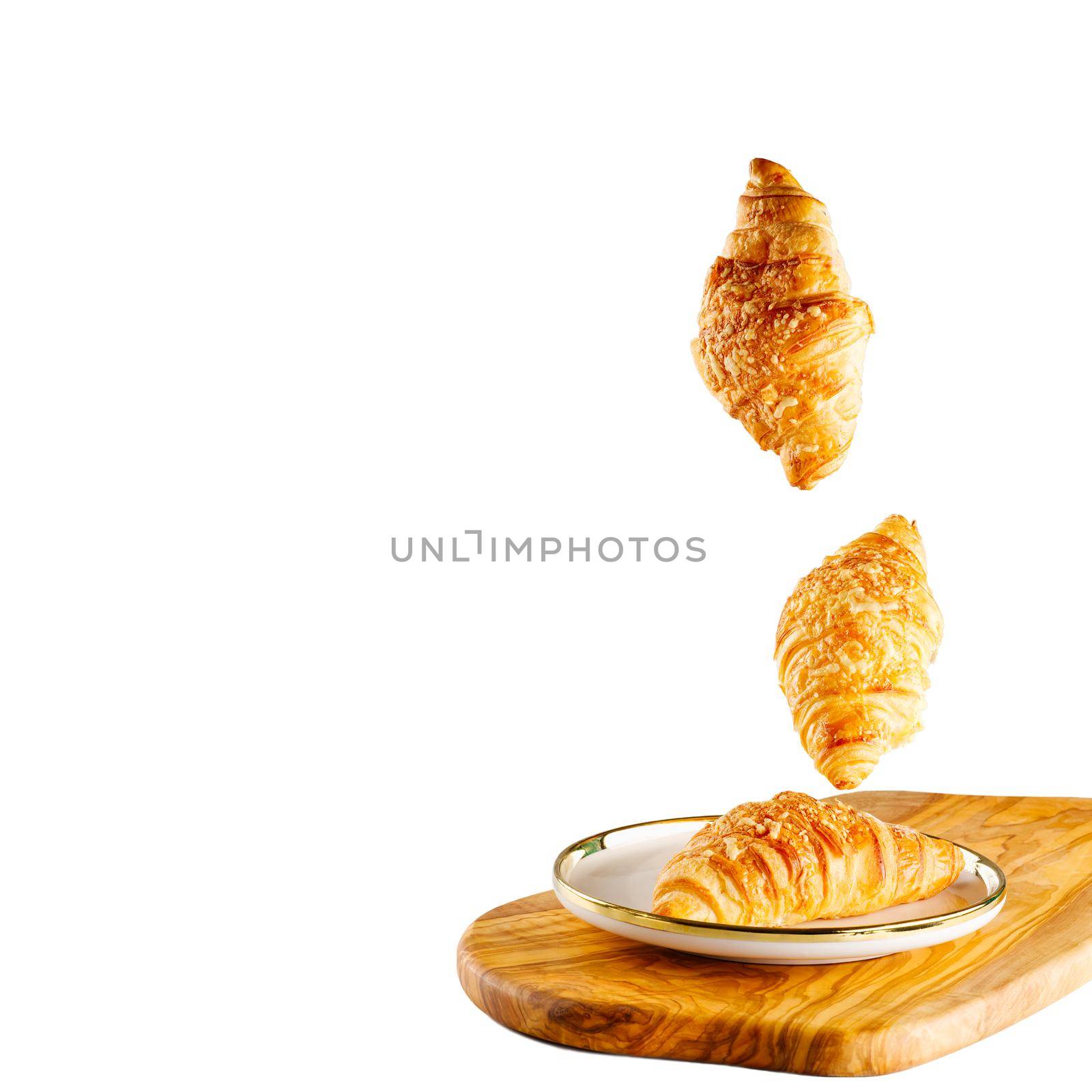 Falling fresh baked croissants with cheese. French pastry concept. Bakery pattern with baked croissant. copy space