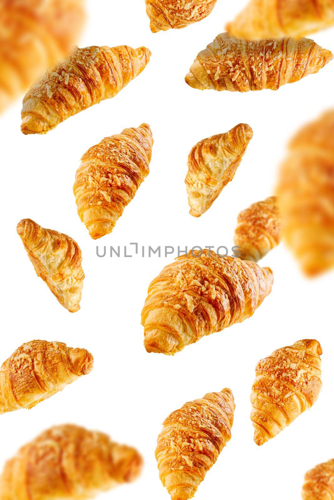 Falling fresh baked croissants with cheese. French pastry concept by PhotoTime