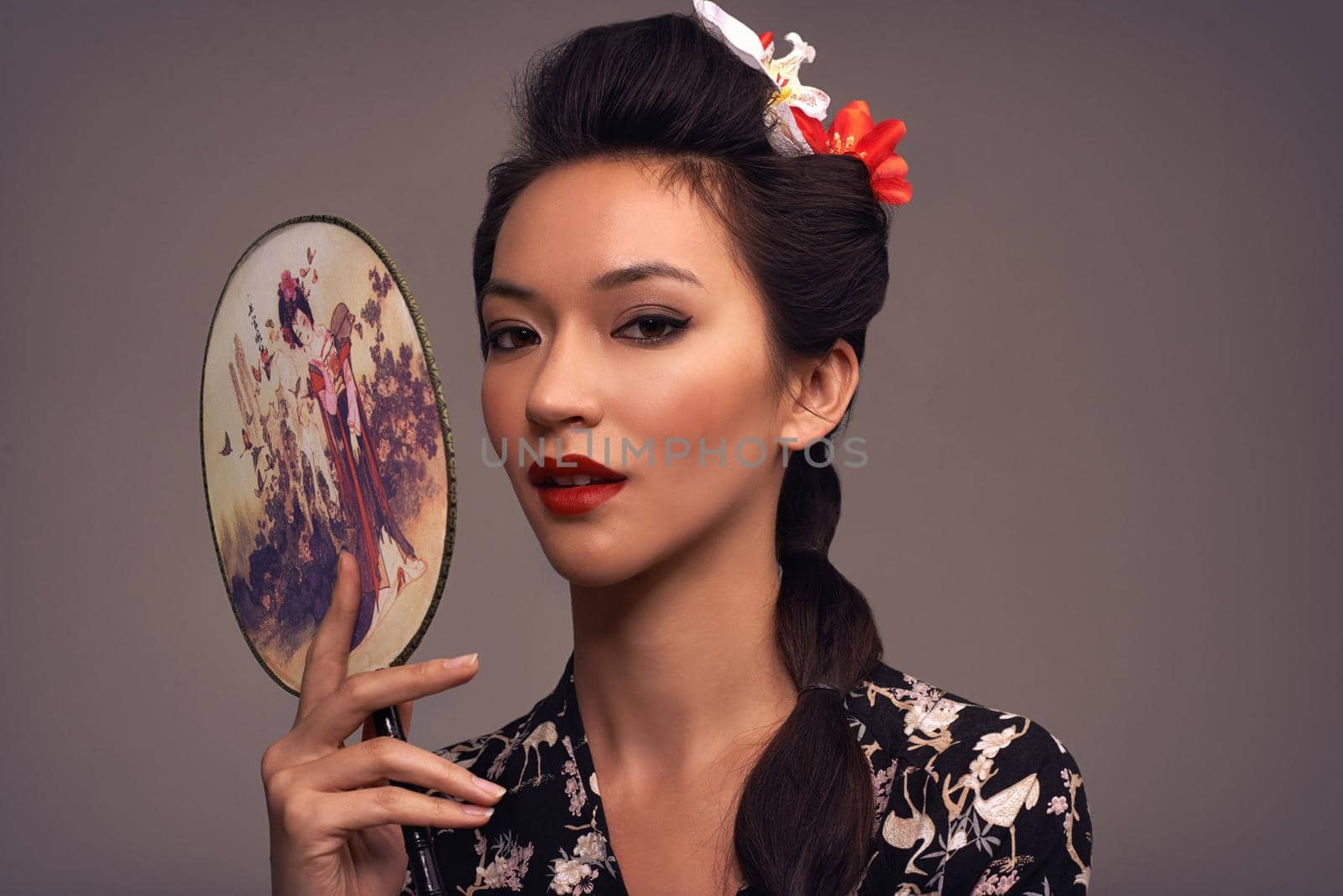 Getting back to my roots. Studio shot of an attractive young woman dressed in traditional asian clothing