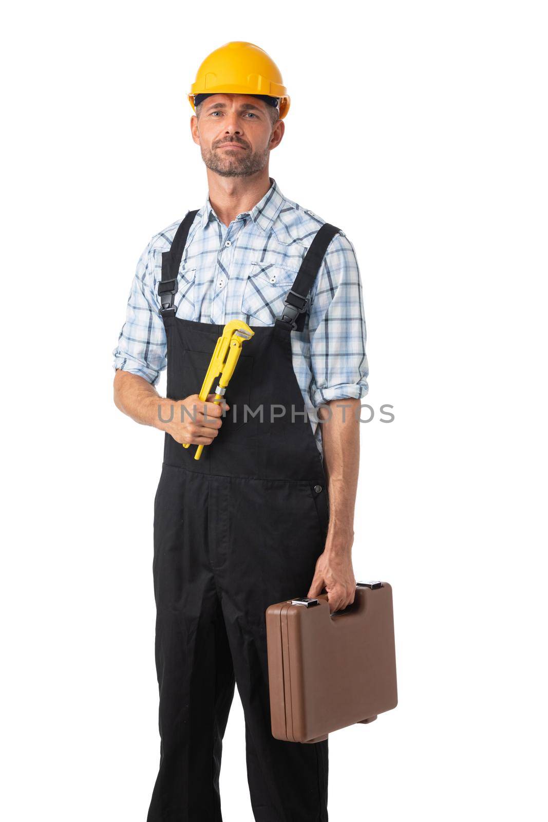 Full length portrait of confident male repairman contractor worker in coveralls holding adjustable spanner and toolbox on white background