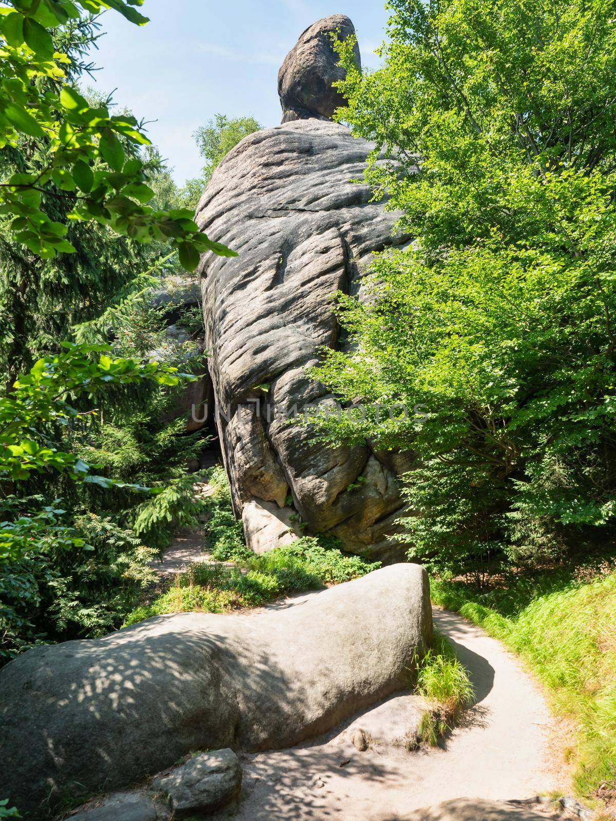 The Fat man rock. The symbol of stony guardian at tourist path to Hvezda chapel, Broumovske wall, stony labyrinth at north of Czechia.
