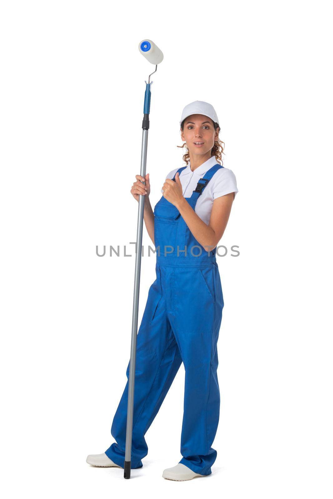 Female house painter in blue coveralls with paint roller tool isolated on white background