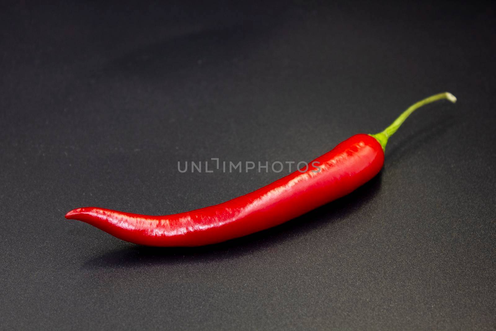 Red hot natural chili pepper. Fresh organic  chili pepper on black